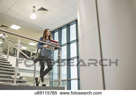 Young woman on staircase View Large Photo Image Stock Photography - Young woman on staircase. Fotosearch