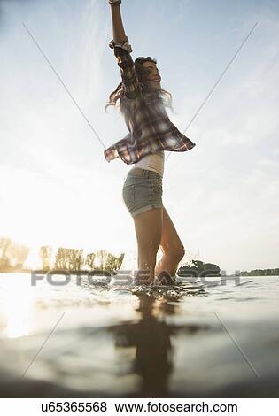 Young woman paddling in lake View Large Photo Image Stock Photo - Young woman paddling in lake. Fotosearch