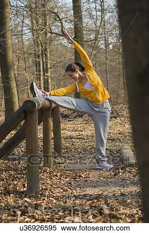 Young woman stretching on forest assault course View Large Photo Image Stock Photography - Young woman stretching on forest assault course. Fotosearch