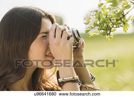 Young woman taking photograph View Large Photo Image Stock Image - Young woman taking photograph. Fotosearch
