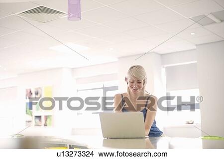 Young woman using laptop View Large Photo Image Picture - Young woman using laptop. Fotosearch