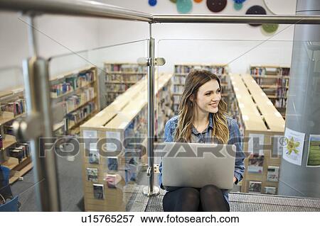 Stock Photo - Young woman using laptop. Fotosearch