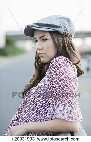 Young woman wearing flat cap View Large Photo Image Stock Image - Young woman wearing flat cap. Fotosearch