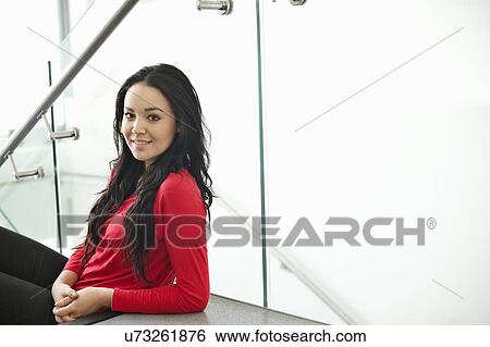 Stock Photograph - Young woman with long black hair, portrait. Fotosearch