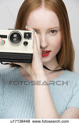 Young woman with polaroid camera View Large Photo Image Stock Photo - Young woman with polaroid camera. Fotosearch