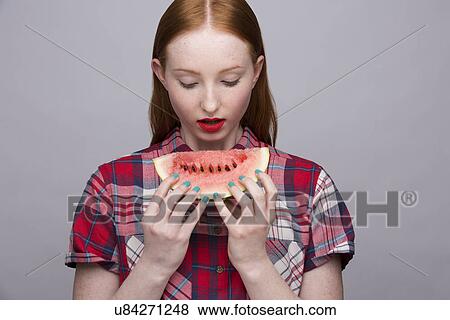 Stock Photo - Young woman with slice of watermelon. Fotosearch