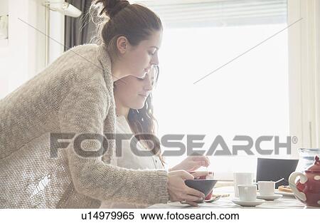 Young women having breakfast View Large Photo Image Stock Photography - Young women having breakfast. Fotosearch