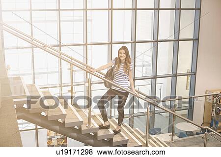 Stock Photo - Young women standing on staircase. Fotosearch