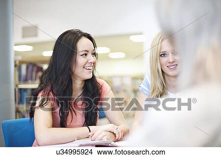 Picture - Young women talking. Fotosearch