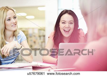Stock Image - Young women talking. Fotosearch