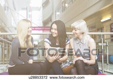 Stock Image - Young women using digital tablet. Fotosearch