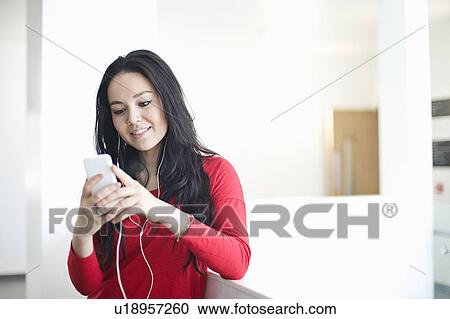Young women using mp3 player View Large Photo Image Stock Image - Young women using mp3 player. Fotosearch