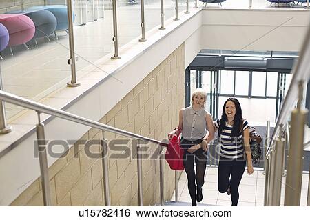 Young women walking up staircase View Large Photo Image Stock Photograph - Young women walking up staircase. Fotosearch