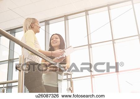 Young women with digital tablet View Large Photo Image Stock Photograph - Young women with digital tablet. Fotosearch