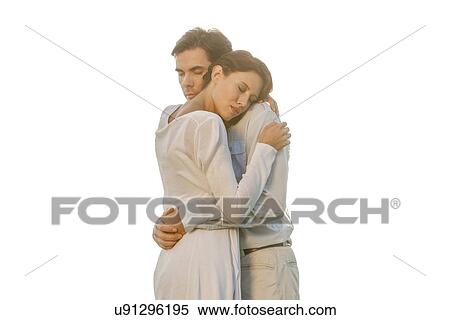 Affectionate young couple with eyes closed hugging in park against clear sky View Large Photo Image Stock Photography - Affectionate young couple with eyes closed hugging in park against clear sky. Fotosearch