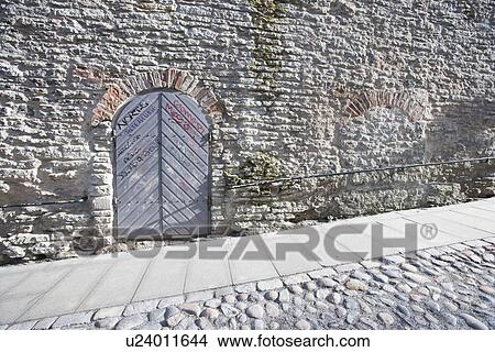 Ancient door by cobblestone street, Tallinn, Estonia, Europe View Large Photo Image Picture - Ancient door by cobblestone street, Tallinn, Estonia, Europe. Fotosearch