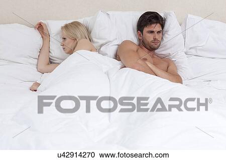 Angry young couple lying in bed View Large Photo Image Stock Image - Angry young couple lying in bed. Fotosearch
