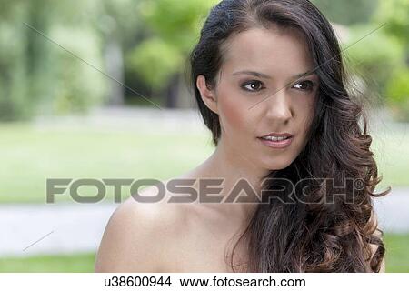 Beautiful young brunette woman looking away in park View Large Photo Image Picture - Beautiful young brunette woman looking away in park. Fotosearch