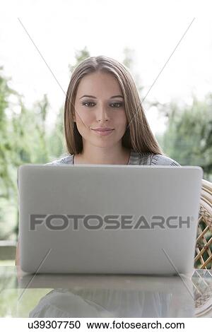 Beautiful young woman using laptop outdoors View Large Photo Image Stock Image - Beautiful young woman using laptop outdoors. Fotosearch
