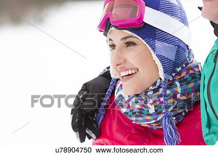 Beautiful young woman with male friend looking away in winter View Large Photo Image Stock Image - Beautiful young woman with male friend looking away in winter. Fotosearch