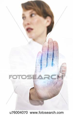 Stock Image - Businesswoman looking away while touching visual screen over white background. Fotosearch