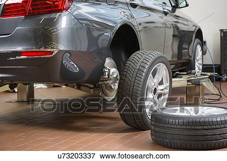 Car and tires at repair shop View Large Photo Image Stock Photo - Car and tires at repair shop. Fotosearch