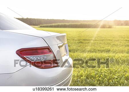 Stock Image - Car on country road. Fotosearch