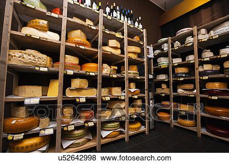 Cheese arranged in shelves at store View Large Photo Image Stock Photo - Cheese arranged in shelves at store. Fotosearch