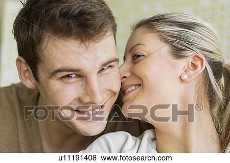 Close-up beautiful young woman kissing man View Large Photo Image Stock Photo - Close-up beautiful young woman kissing man. Fotosearch