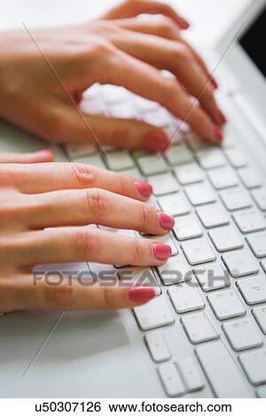 Close-up of businesswoman using laptop View Large Photo Image Stock Photograph - Close-up of businesswoman using laptop. Fotosearch