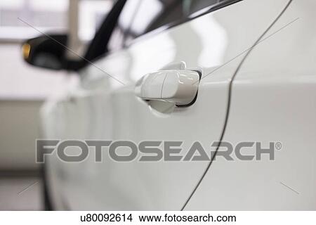 Picture - Close-up of white car in repair store. Fotosearch