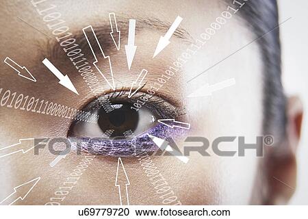 Stock Image - Close-up portrait of businesswoman with binary digits and arrow signs moving towards his eye. Fotosearch