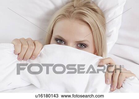 Close-up portrait of young woman covering face with bed sheet View Large Photo Image Stock Image - Close-up portrait of young woman covering face with bed sheet. Fotosearch