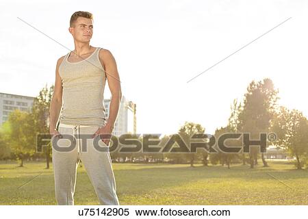 Stock Photography - Confident jogger standing in park. Fotosearch