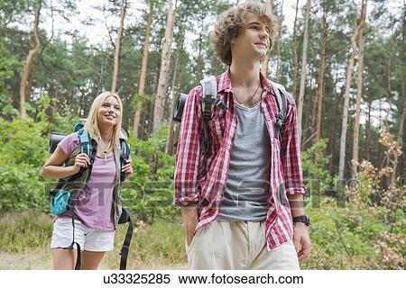 Stock Photography - Couple hiking in forest. Fotosearch