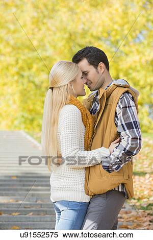 Stock Photography - Couple kissing in park during autumn. Fotosearch