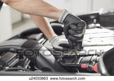 Cropped image of automobile mechanic repairing car in automobile store View Large Photo Image Stock Image - Cropped image of automobile mechanic repairing car in automobile store. Fotosearch