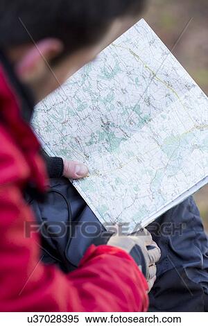 Stock Photography - Cropped image of male hiker reading map. Fotosearch