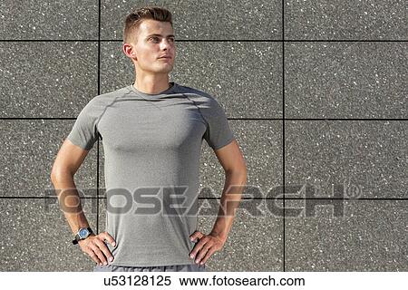 Determined jogger standing against tiled wall outdoors View Large Photo Image Stock Photography - Determined jogger standing against tiled wall outdoors. Fotosearch