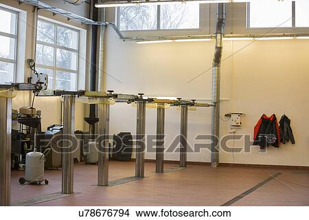 Picture - Empty hoists at automobile repair shop. Fotosearch