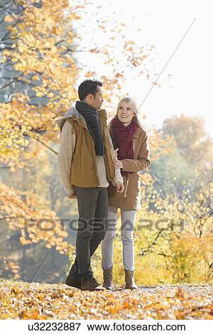 Full length of couple walking in park during autumn View Large Photo Image Stock Photo - Full length of couple walking in park during autumn. Fotosearch