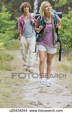 Full length of hiking couple in forest View Large Photo Image Picture - Full length of hiking couple in forest. Fotosearch