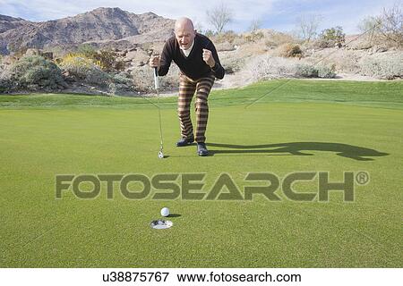 Full length of senior male golfer celebrating a putt at golf course View Large Photo Image Stock Photo - Full length of senior male golfer celebrating a putt at golf course. Fotosearch