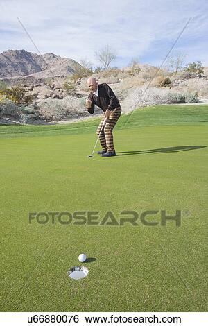 Full length of senior male golfer celebrating sinking putt at golf course View Large Photo Image Stock Photograph - Full length of senior male golfer celebrating sinking putt at golf course. Fotosearch