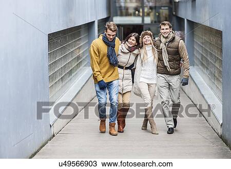 Full length of young friends on walkway View Large Photo Image Stock Image - Full length of young friends on walkway. Fotosearch