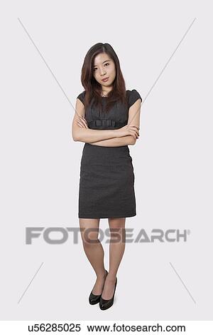 Full length portrait of beautiful young businesswoman standing arms crossed over white background View Large Photo Image Stock Photography - Full length portrait of beautiful young businesswoman standing arms crossed over white background. Fotosearch