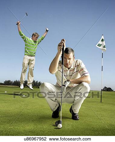 Full length portrait of golfer lining up shot with man jumping in background View Large Photo Image Stock Image - Full length portrait of golfer lining up shot with man jumping in background. Fotosearch