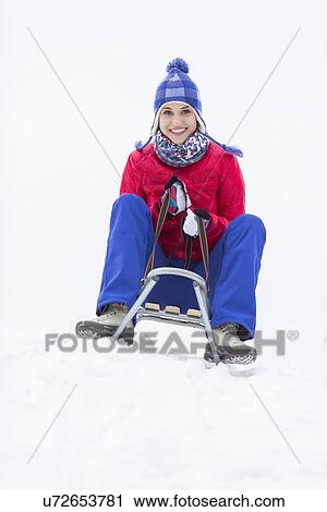 Full length portrait of happy young woman enjoying sled ride in snow View Large Photo Image Stock Image - Full length portrait of happy young woman enjoying sled ride in snow. Fotosearch