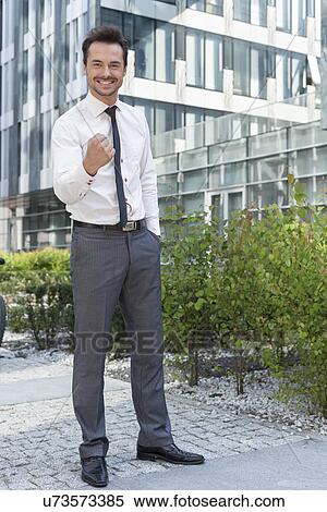 Full length portrait of successful businessman outside office building View Large Photo Image Stock Photography - Full length portrait of successful businessman outside office building. Fotosearch