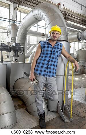 Full length portrait of young worker with wrench in industry View Large Photo Image Stock Photo - Full length portrait of young worker with wrench in industry. Fotosearch
